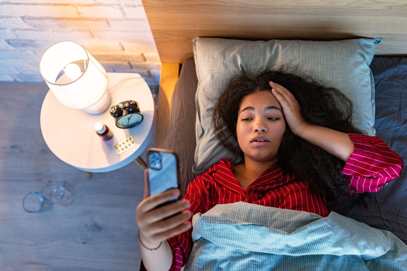 woman having problems sleeping and on her phone
