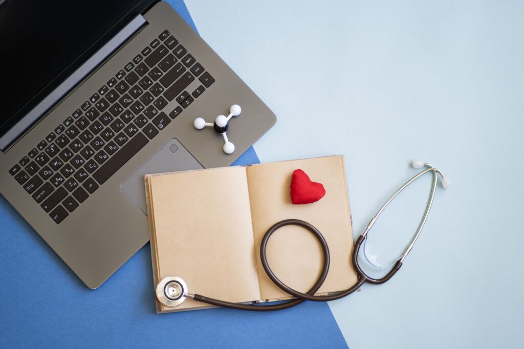 stationary essentials and stethoscope scattered around dual blue background