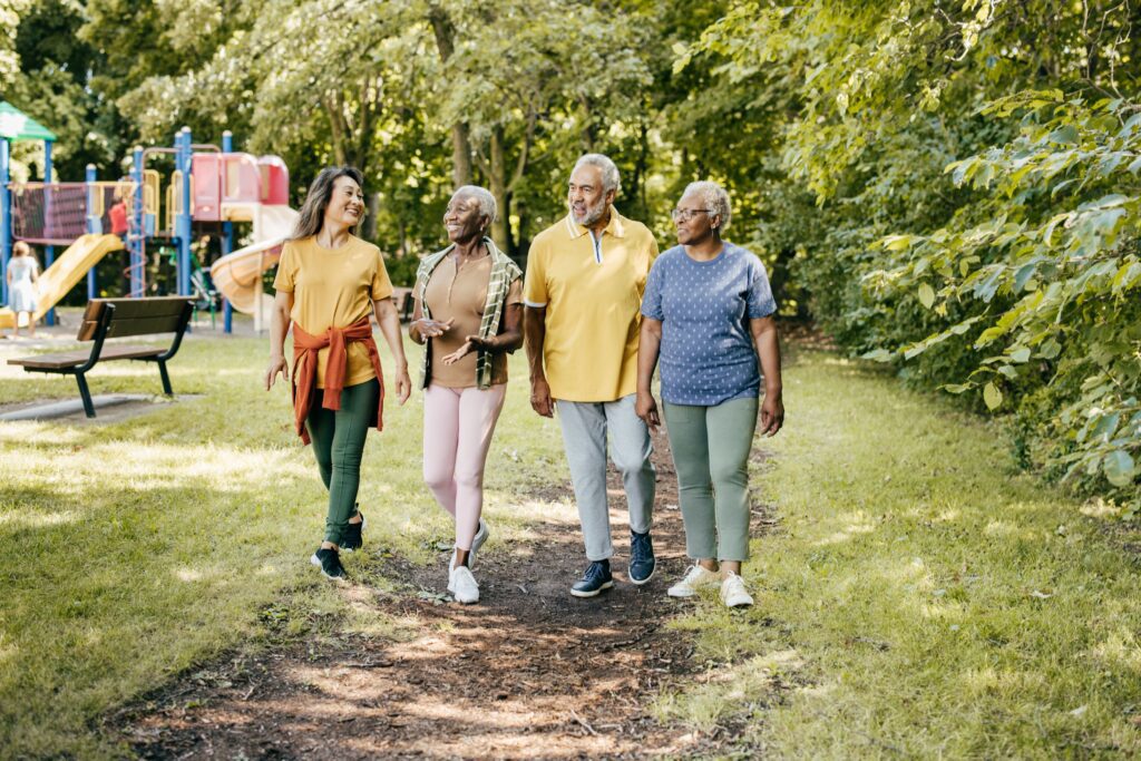 four individuals smiling and walking together