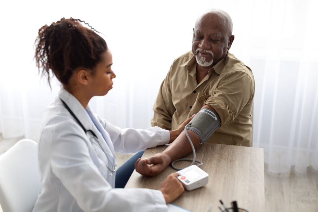 healthcare provider taking senior's blood pressure